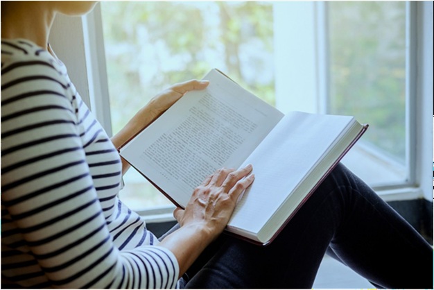 Must-Read Books to Understand the Comfort Women Issue Woman reading a history book by a window, representing research into comfort women history, East Asian wartime historiography, archival sources, survivor testimony, and books about the comfort women debate between Japan and Korea.